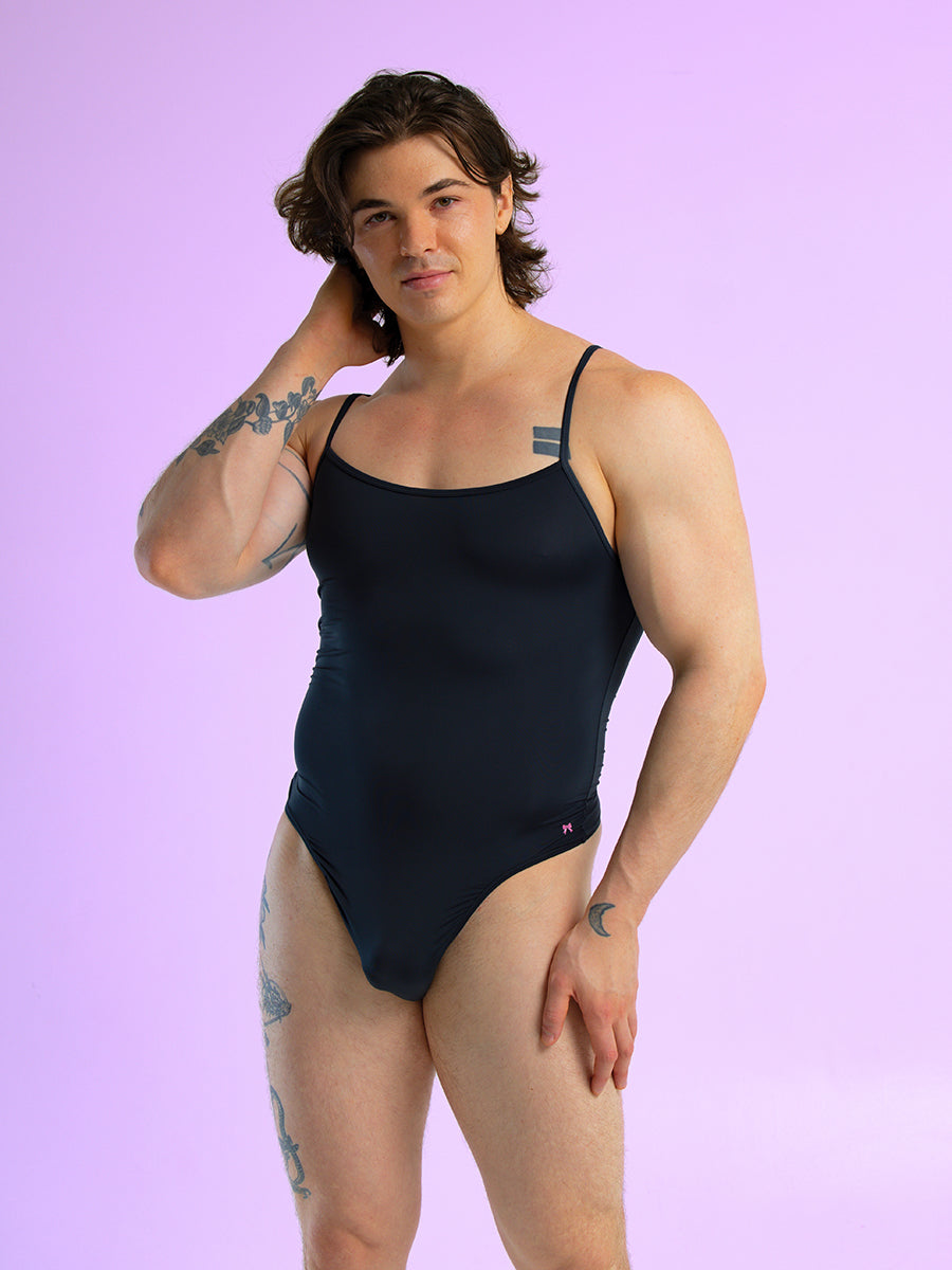 Front view of a man wearing a black bodysuit with thin shoulder straps.