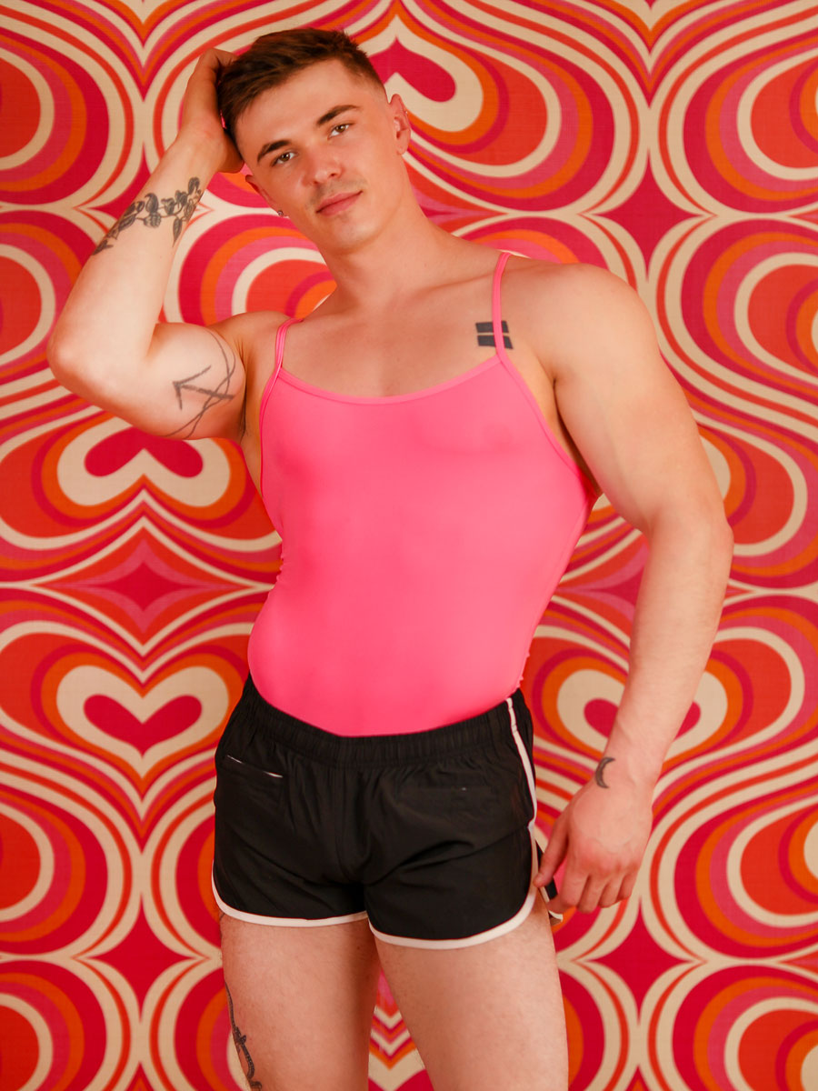 front view of man in an XDress pink thong bodysuit