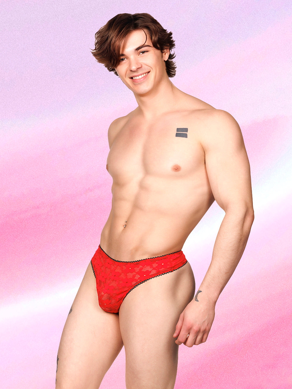 Side view of a male model wearing an XDress red lace thong with black picot trim