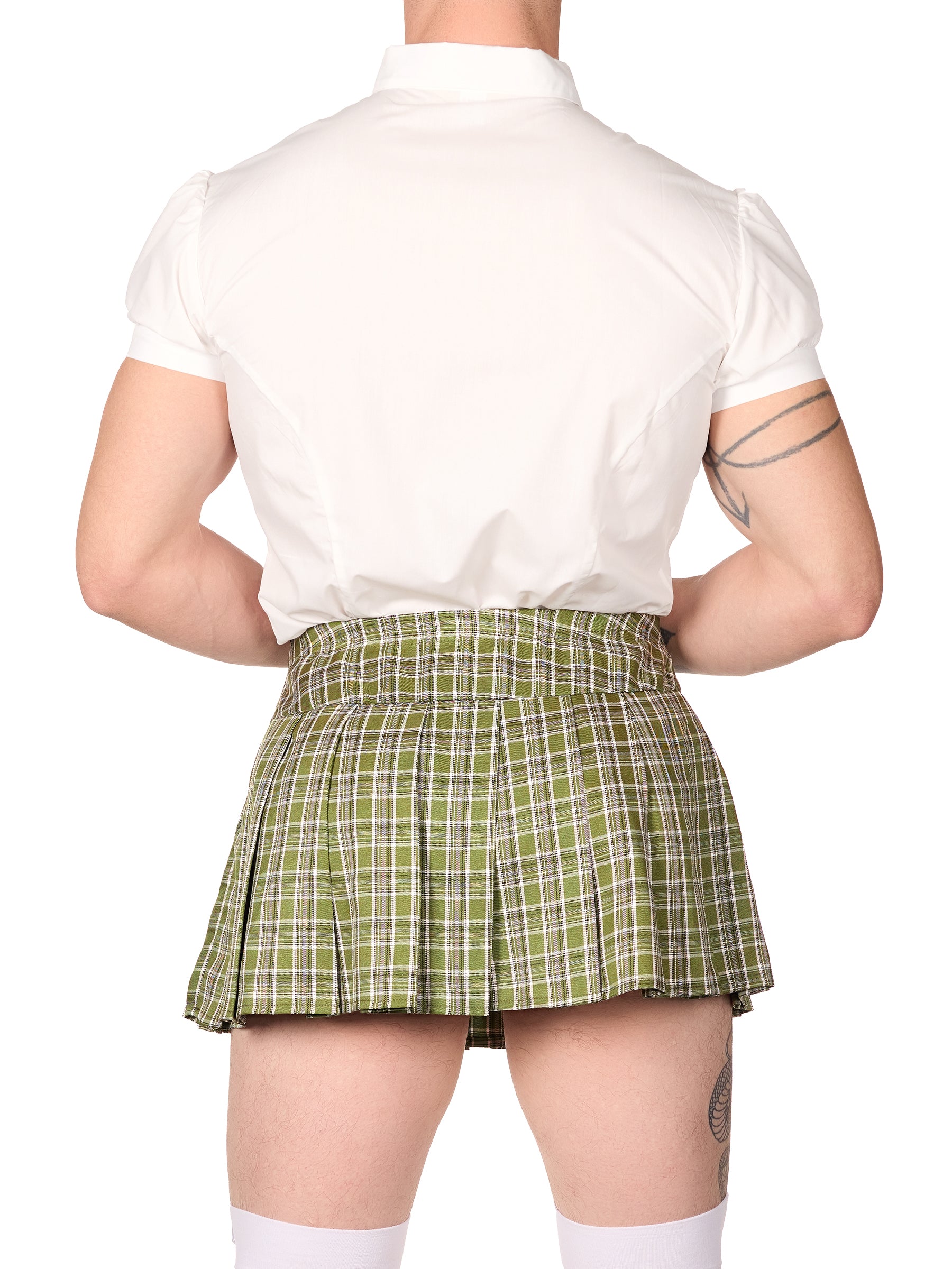 Back view of a male model wearing an XDress schoolgirl outfit for men, consisting of a white short-sleeved button-up shirt with puffed sleeves, a plaid bow tie, and a matching green plaid skirt