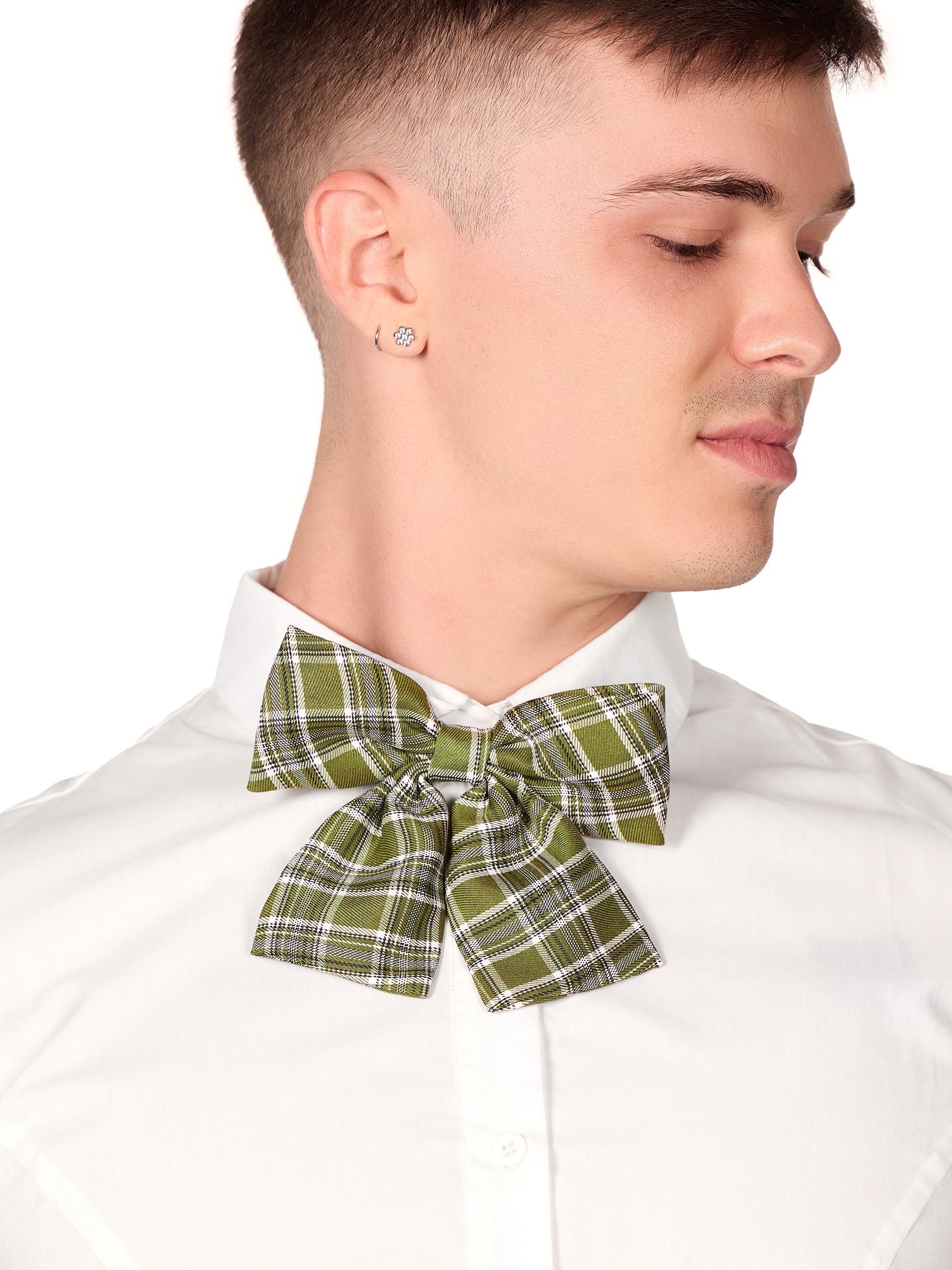 Closeup view of a male model wearing a green plaid bowtie